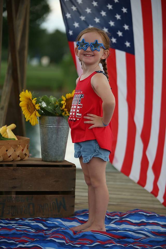young girl with star sunglasses