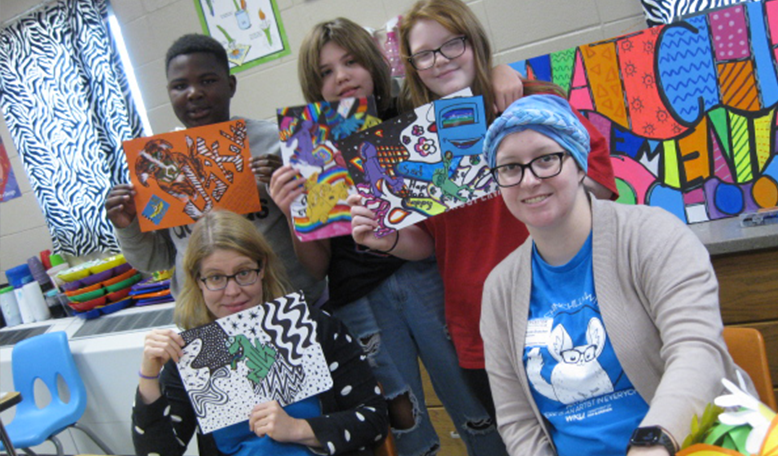 Student Showing Off Artwork