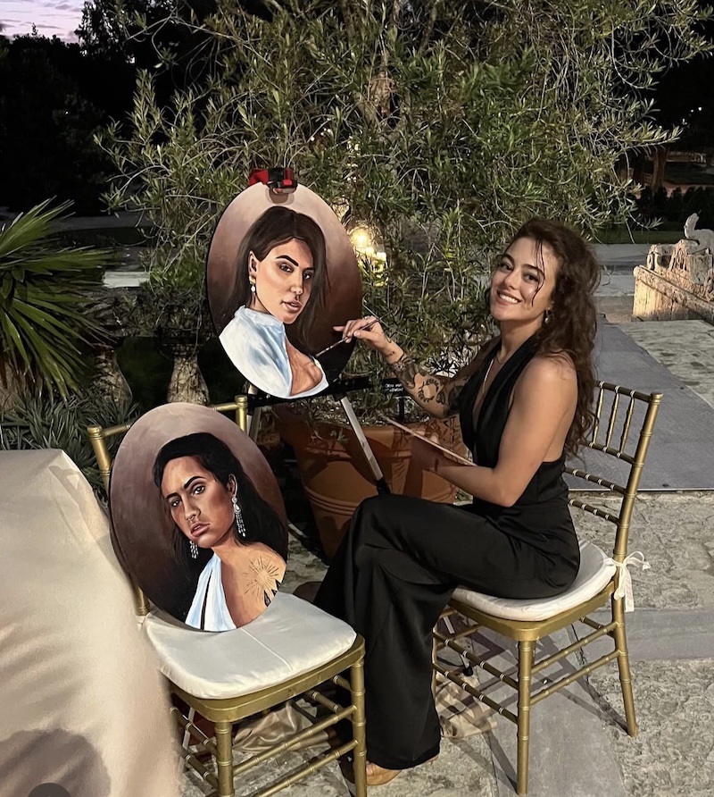 Christina Scott sitting outside painting.