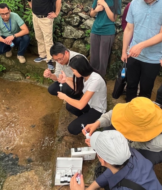 Students learning water testing techniques at a cave spring. CHL China Trip