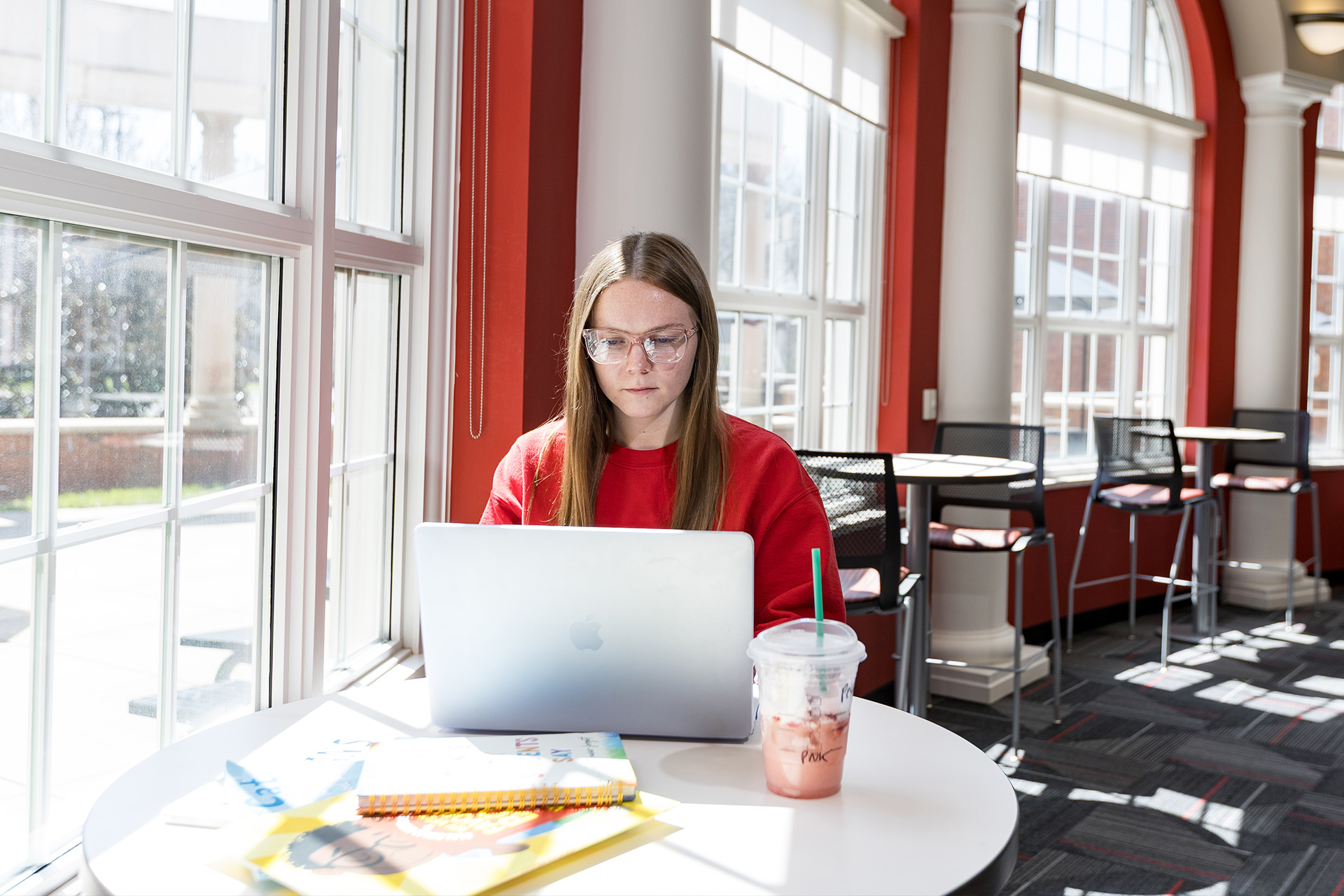 Future WKU teacher candidate diligently studies on her laptop, showcasing the dedicated learning environment for aspiring educators at Western Kentucky University.