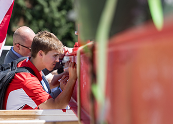 Student signing beam at Beam Raising Ceremony