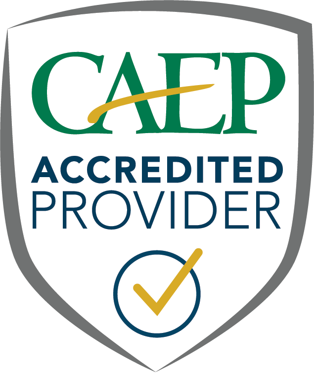 A student graduating during fall commencement with a degree in hand.