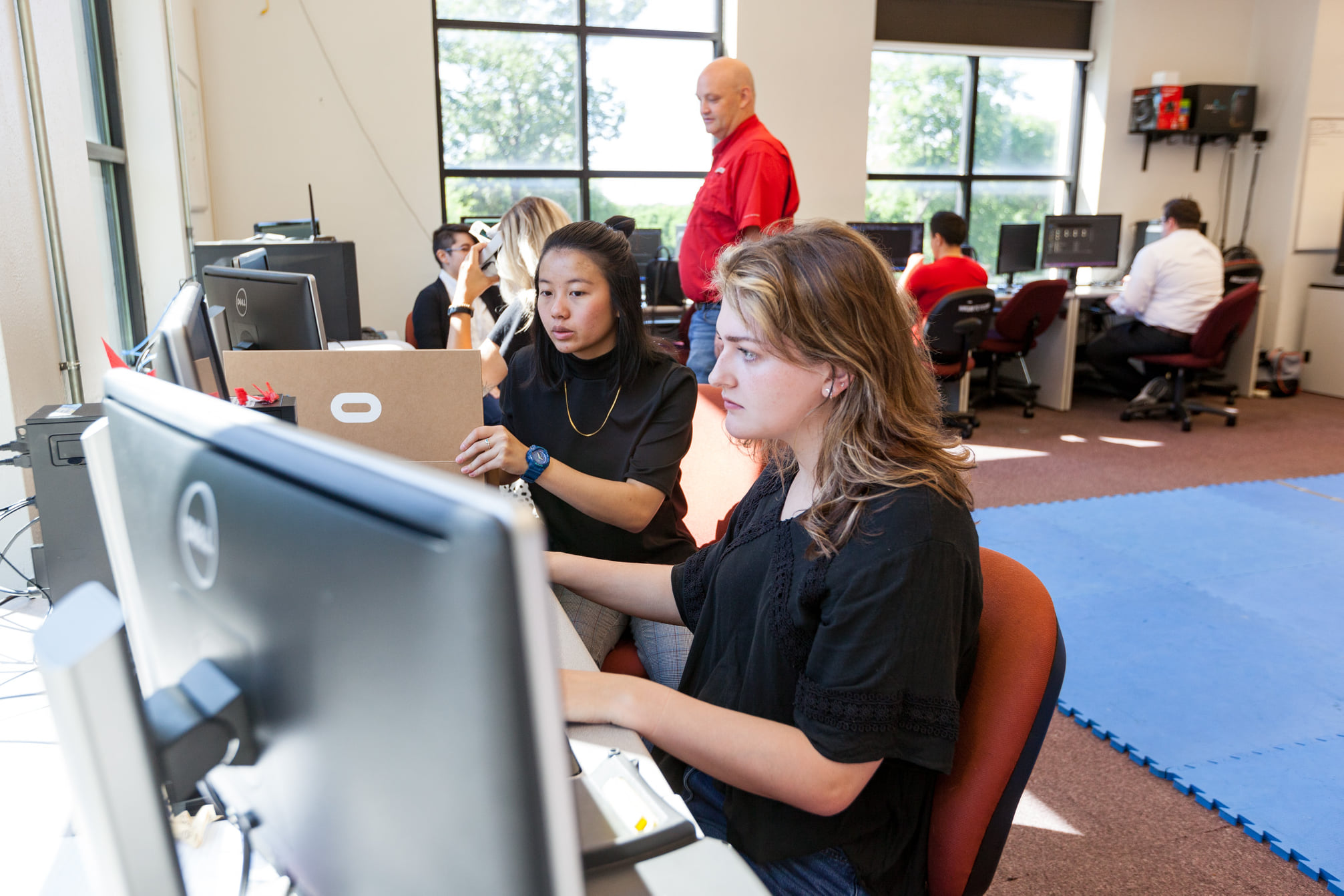 Two students sitting at computers during class