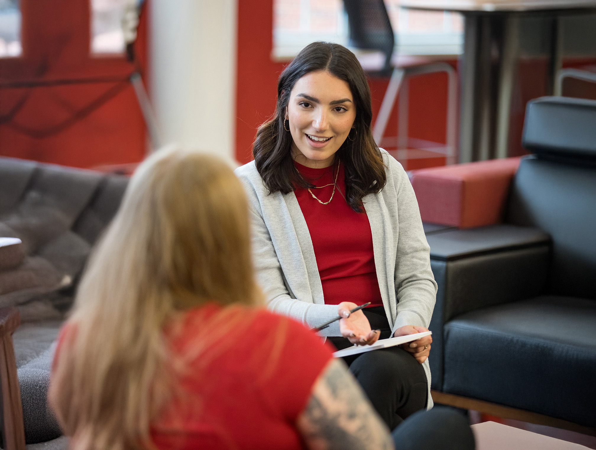 Digital Clinical Mental Health Counseling students sitting around a laptop