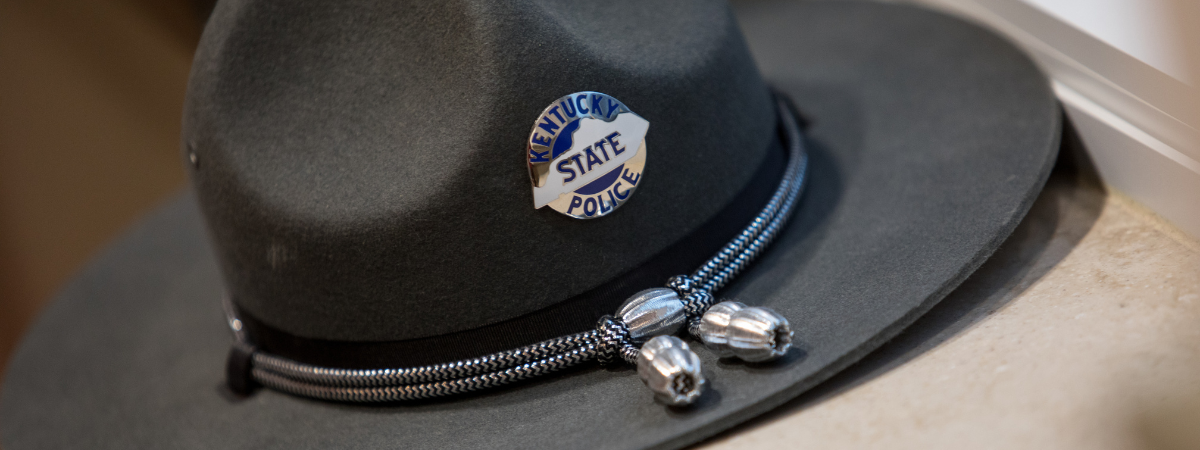 A Kentucky State Police hat rests on a windowsill.