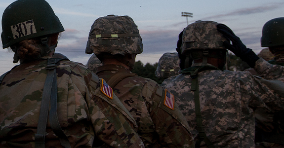 The back of a group of military personnel in uniform.