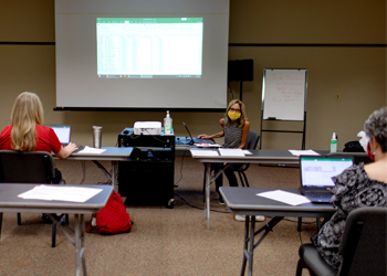 A teacher leads an Excel training.