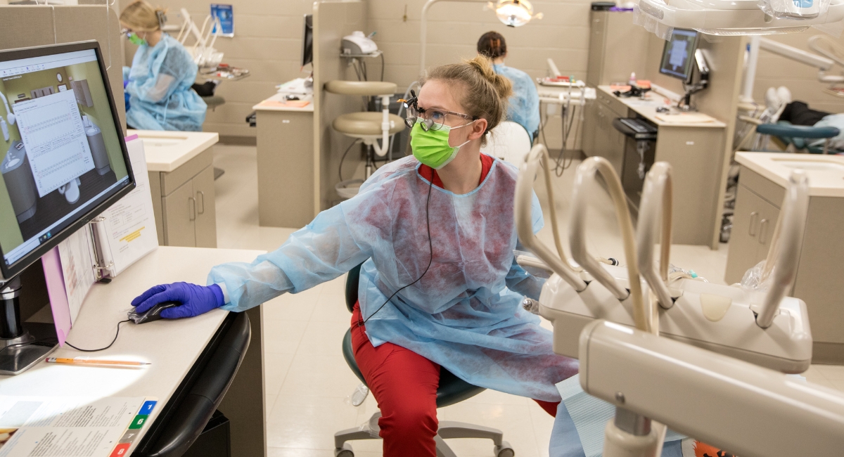 dental hygiene student working in clinic