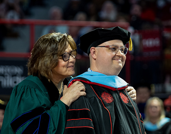 A Ed.D doctoral student during the hooding ceremony during fall commencement.