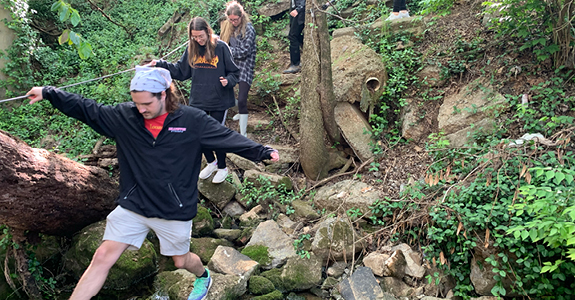 Students walking along rocks