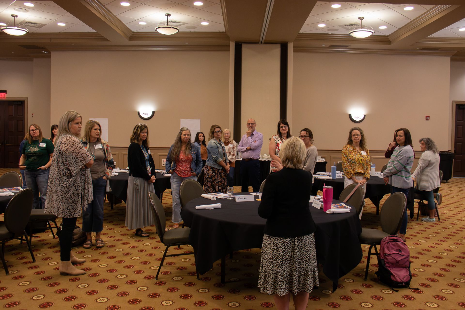 Attendees standing and listening to speaker Julia Roberts