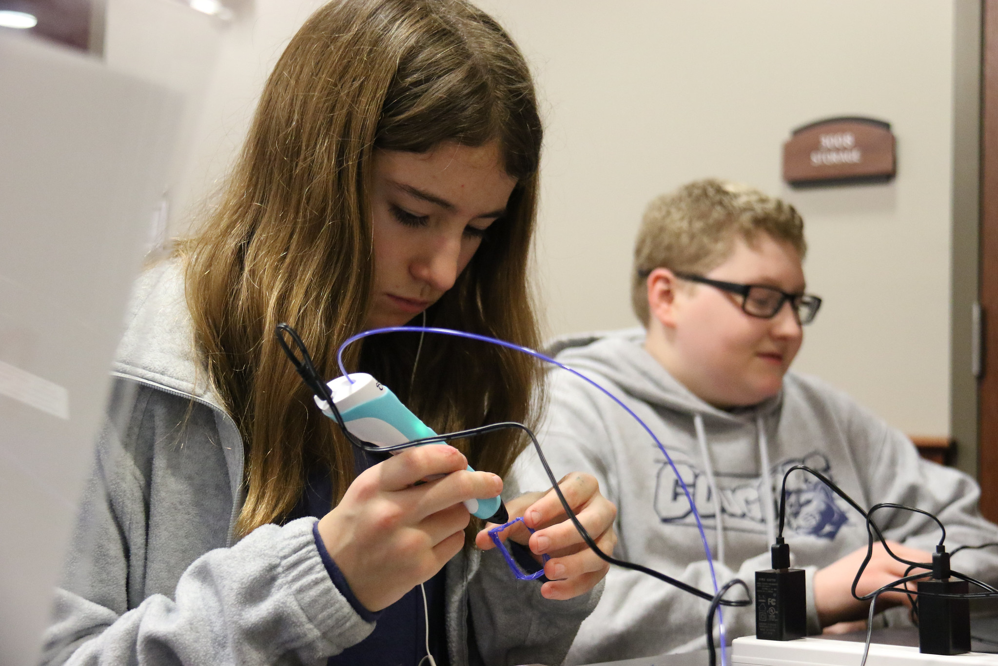 two students using 3D pens