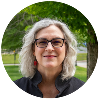 image of woman with silver hair and glasses
