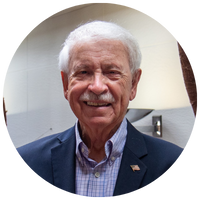 image of man with white hair, mustache, and blue blazer