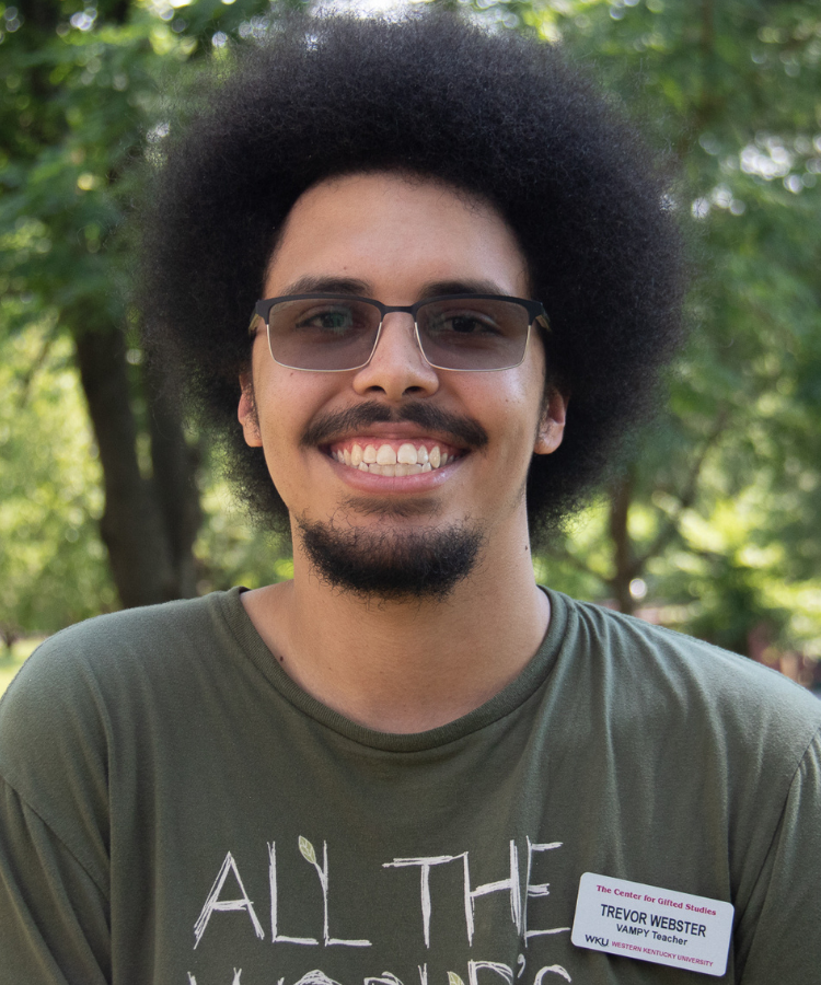 man in green tshirt, smiling at the camera