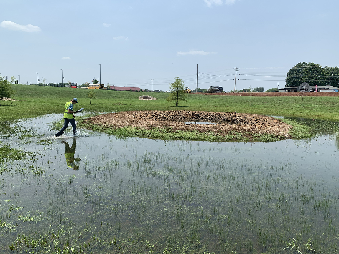 Student Walking in Water and Grass