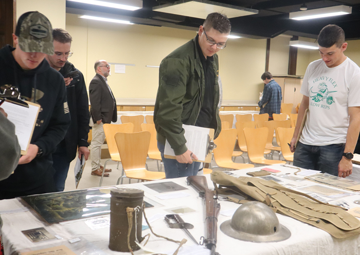 Student looking at military artifacts