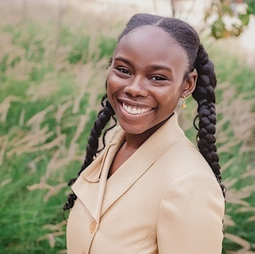 Tani Washington smiling in cream suit