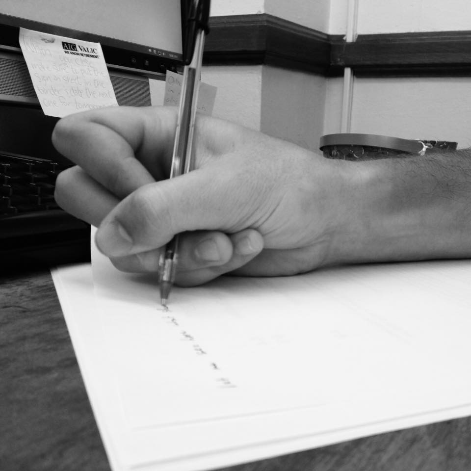 Hand writing on paper in black and white.