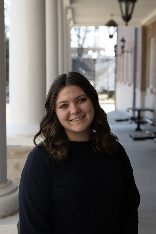 Young brunette women smiling in an outdoor setting