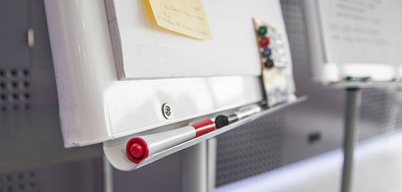 A whiteboard outlining a project with steps