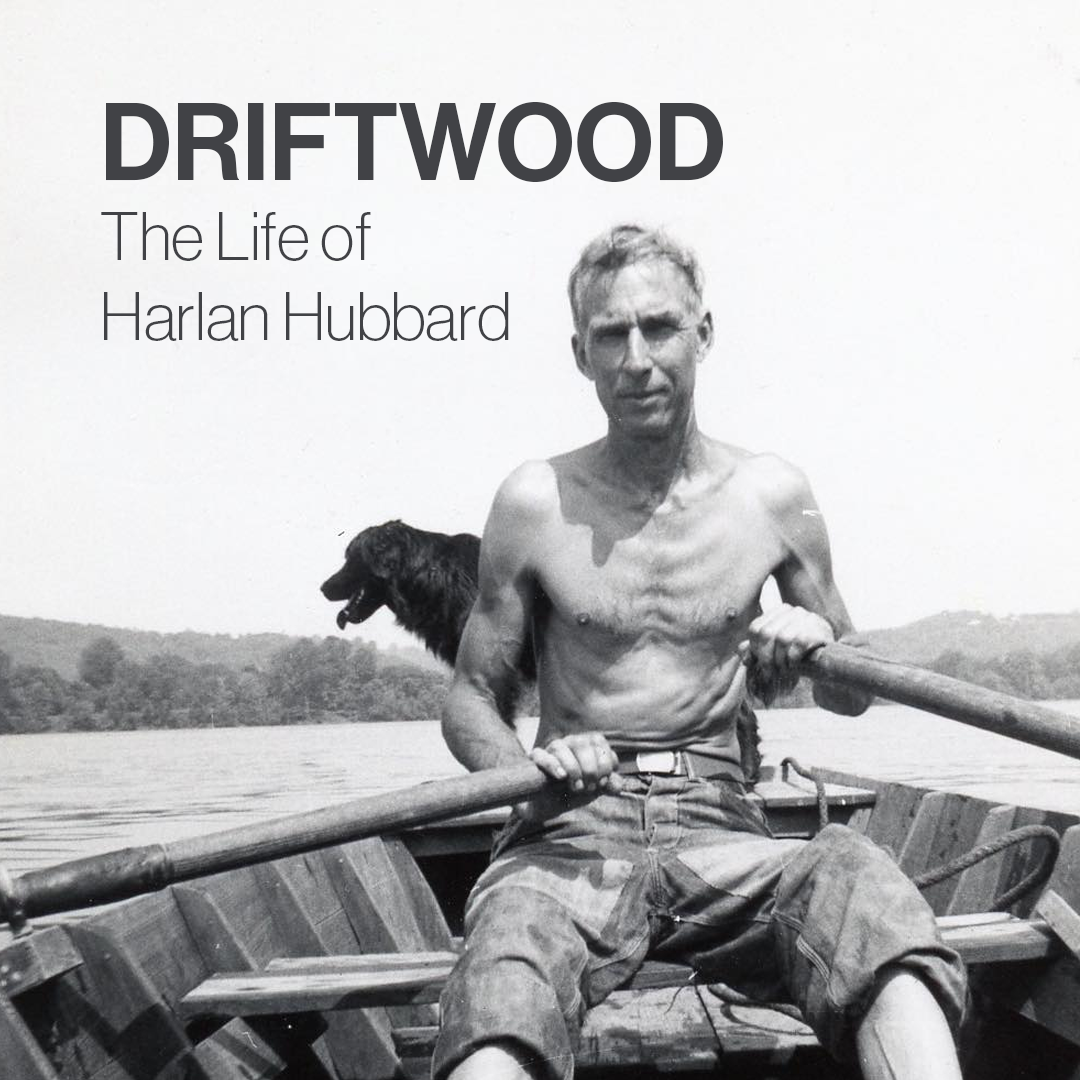 Harland Hubbard in a rowboat with his dog