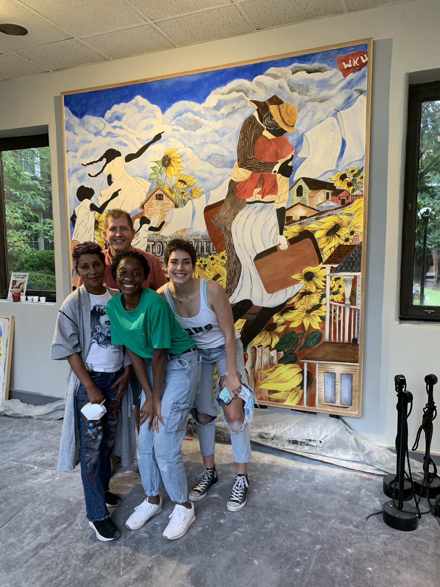 Mural team stands with the finished mural.