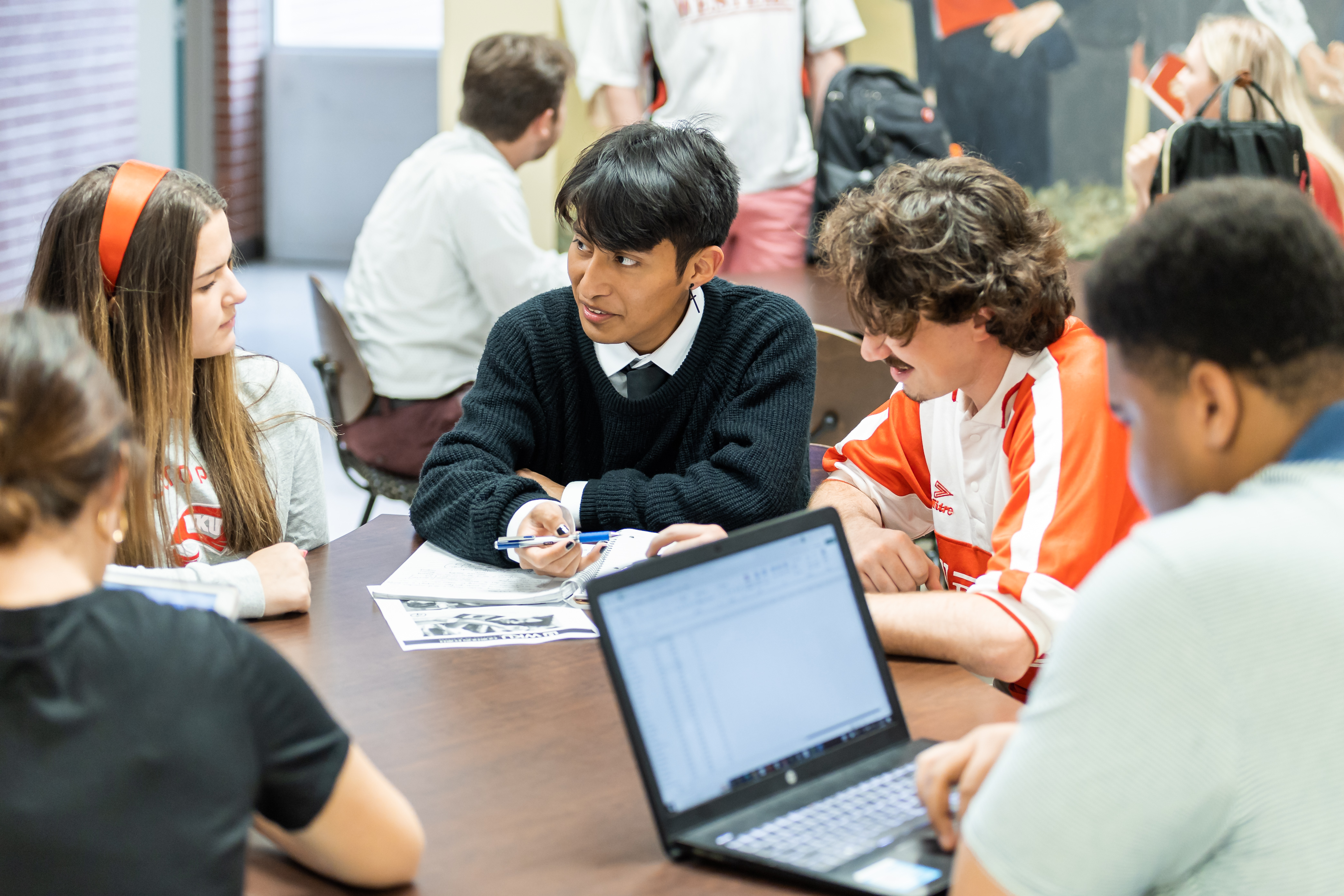 A group of Western Kentucky University students sit and talk together.