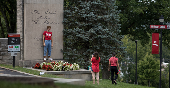 WKU student taking photo near Pylon