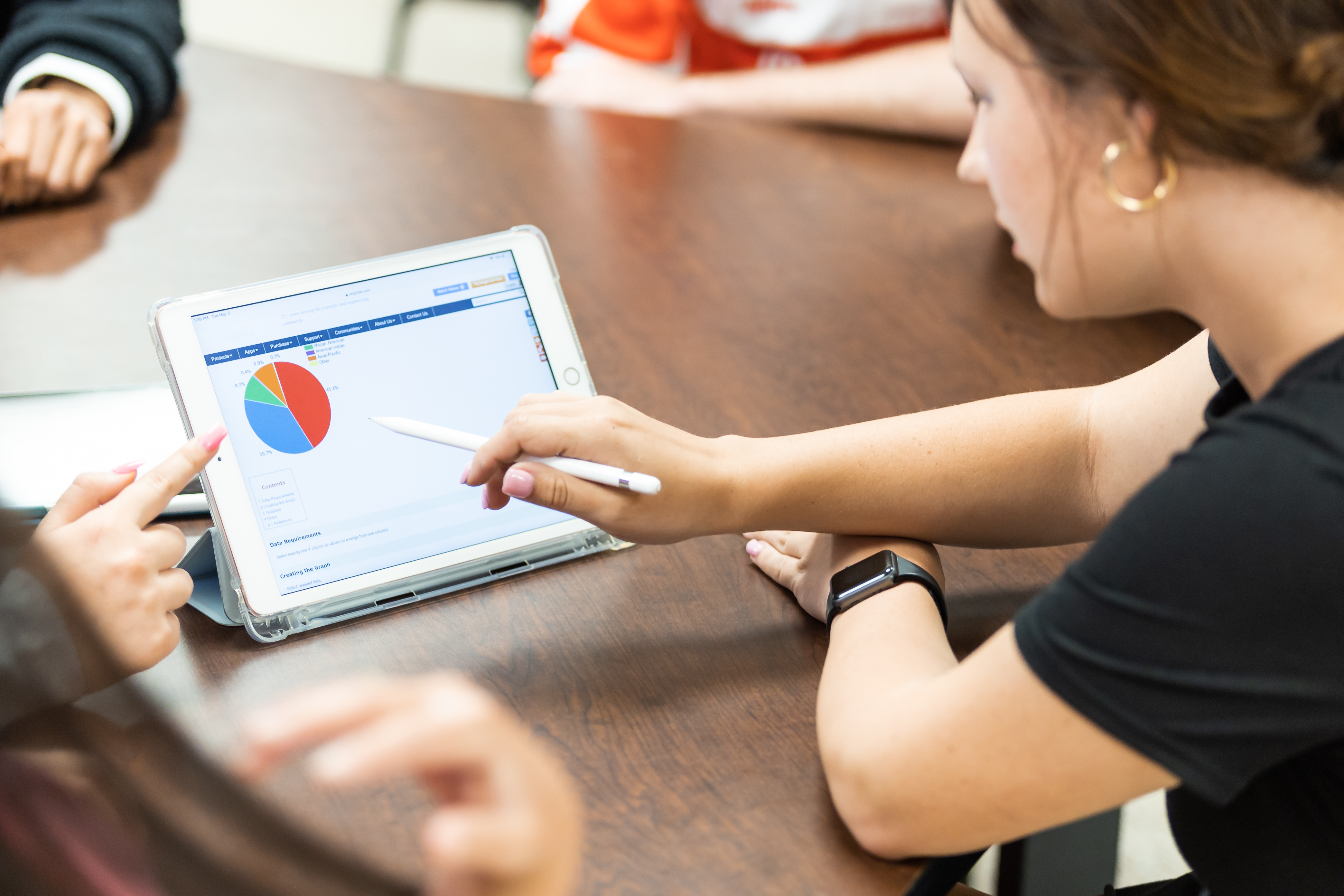 WKU student looks at a chart on a tablet.