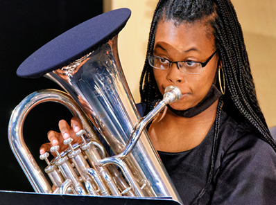 Woman playing a horn.
