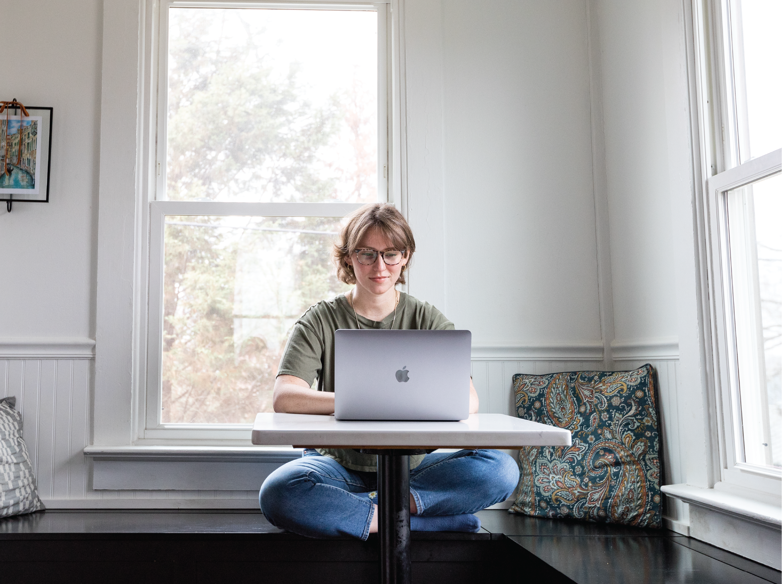 Person working on laptop in kitchen