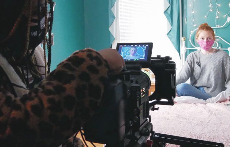 Woman filming a woman image.