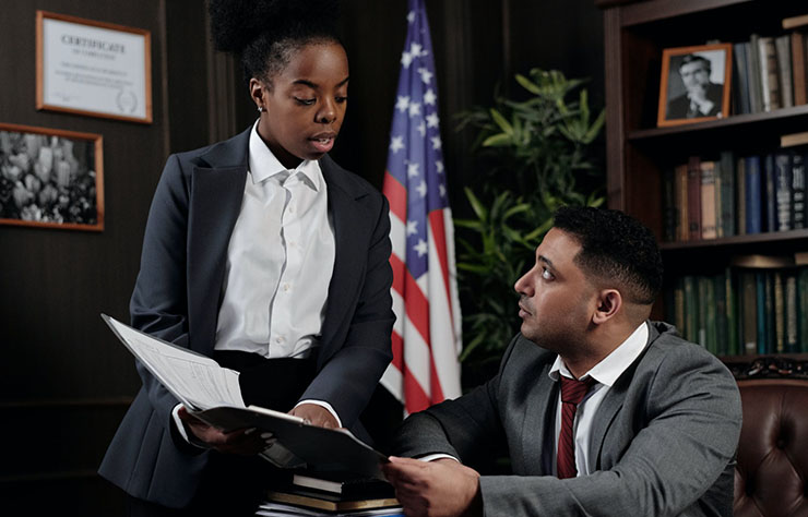 People talking over document.