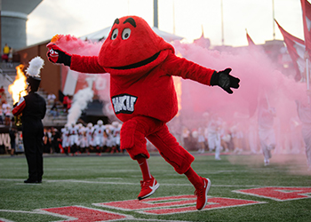 Big Red running across the football field