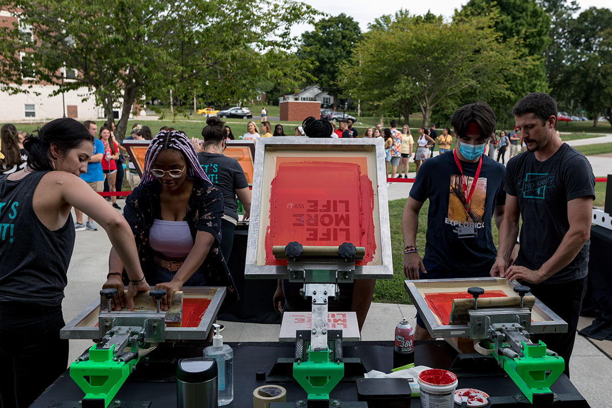 Students screen printing shirts on south lawn. Students screen printing shirts on south lawn.