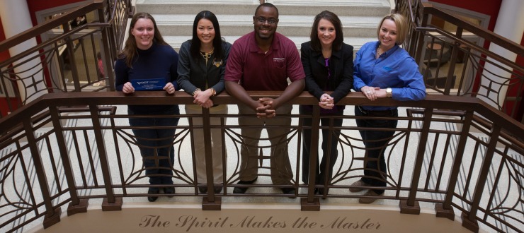 Recent I/O interns proudly displaying their internship apparel