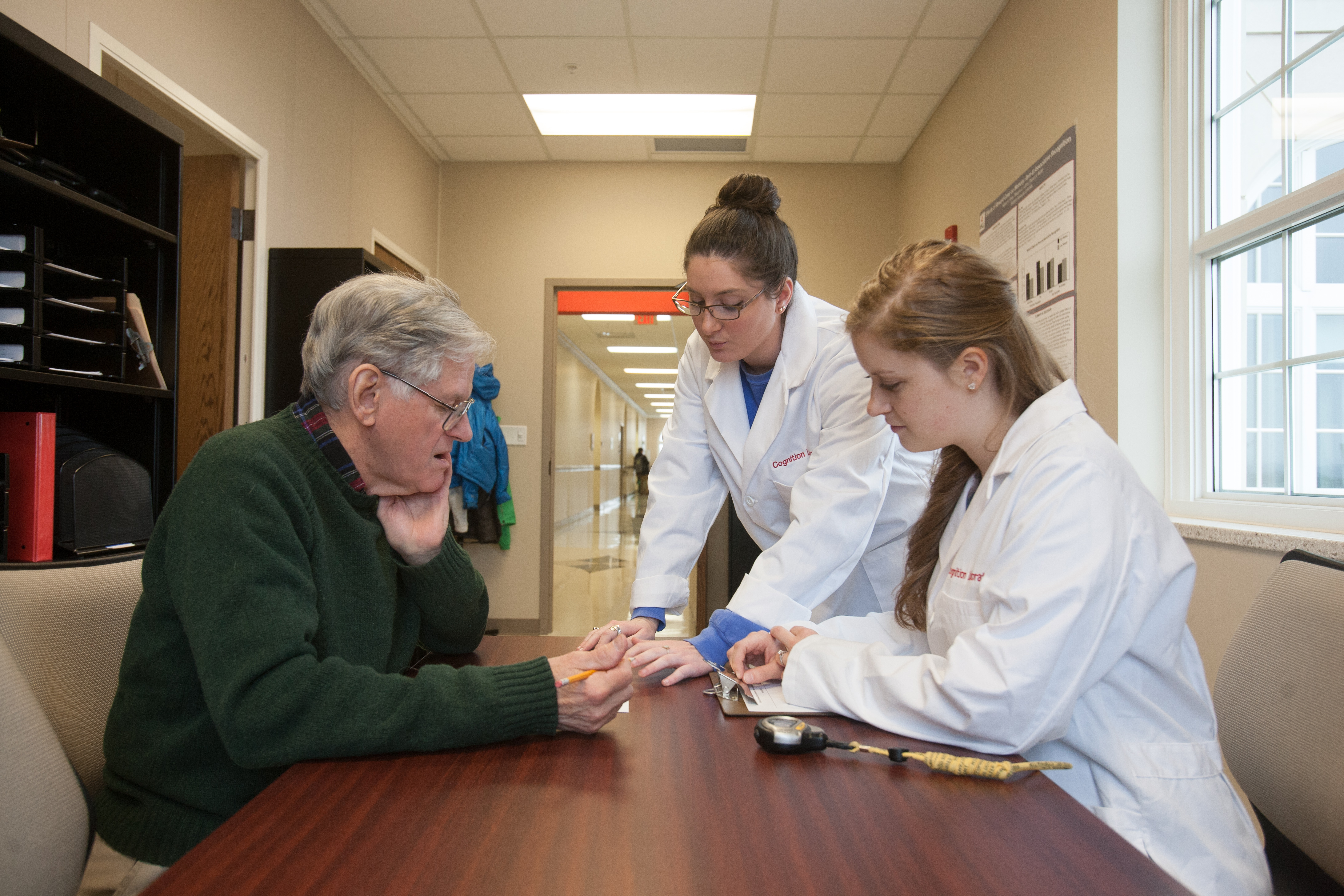 Two WKU students speak to WKU professor.