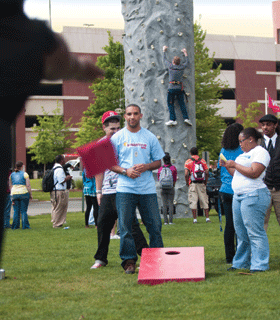 Students climbing and playing cornhole Students climbing and playing cornhole