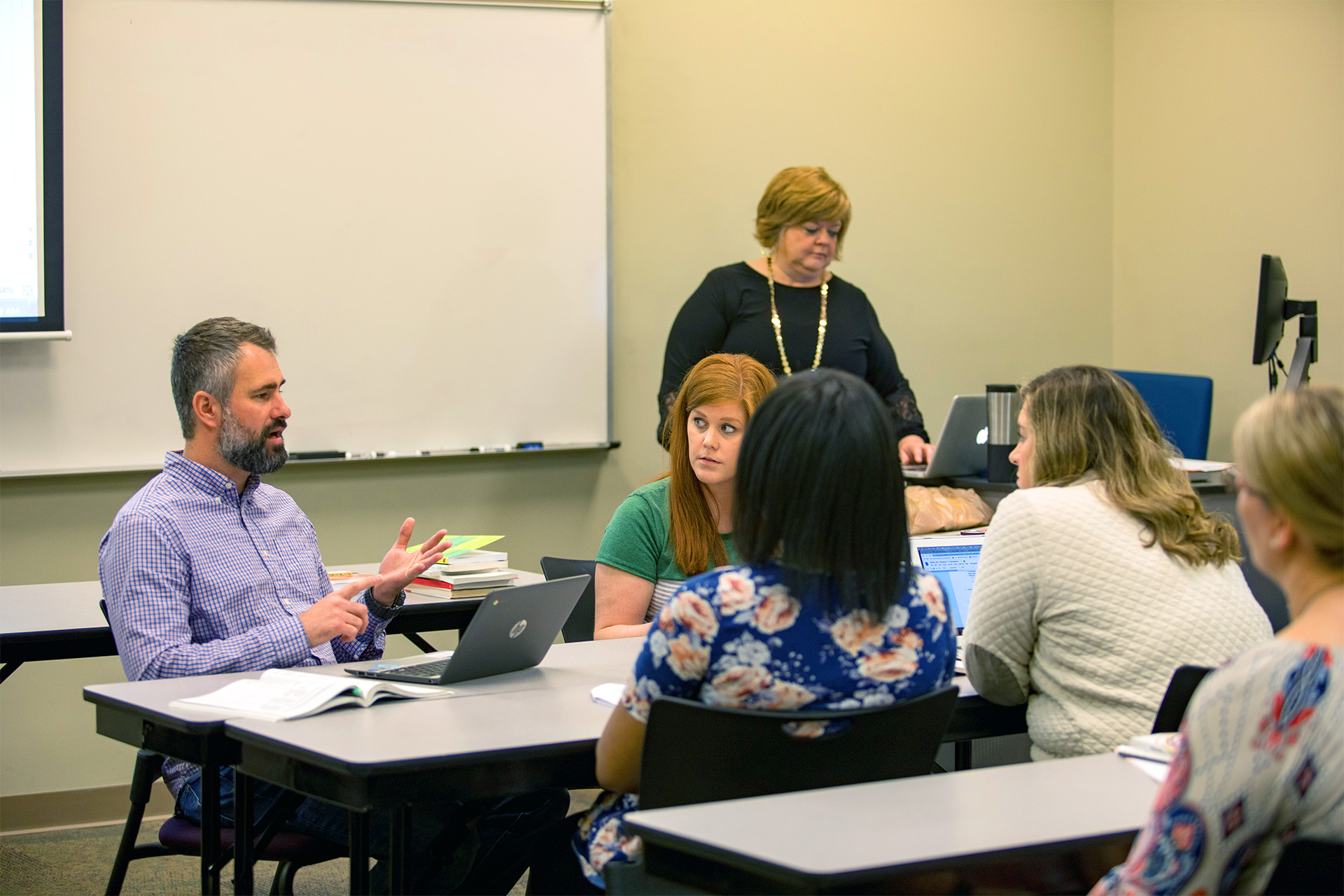 Students in the Instructional Leadership, School Principal program learning in a classroom.