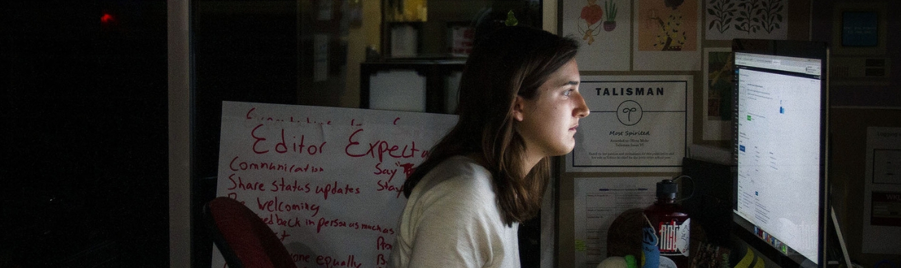 journalism student working on computer