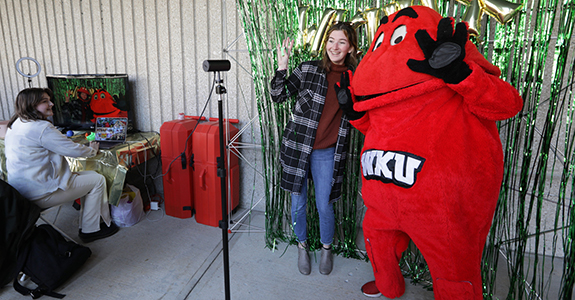 Big Red poses with a student in front of an augmented reality (AR) photobooth.