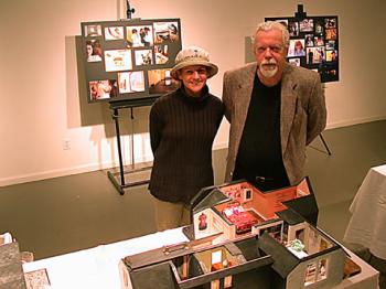 Andee and John displaying pictures of the At Home project